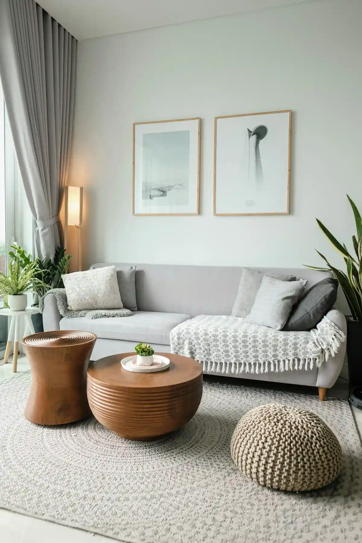 Warm neutral living room showcasing a low wooden side table positioned exactly level with the sofa arm