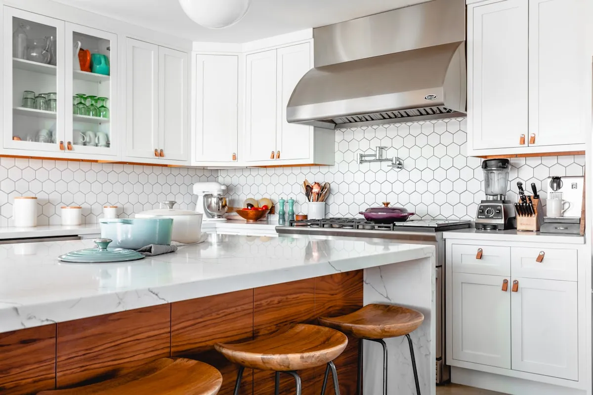 Modern luxury kitchen showcasing the 70/30 rule with warm brushed brass cabinet handles and matte black accent fixtures