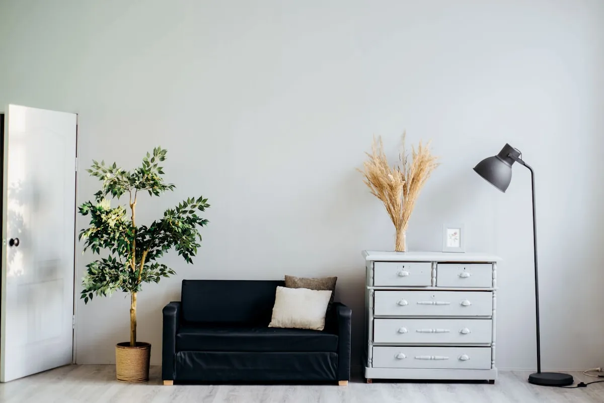 Contemporary rental apartment living room styled with damage-free gallery wall art above a neutral sofa