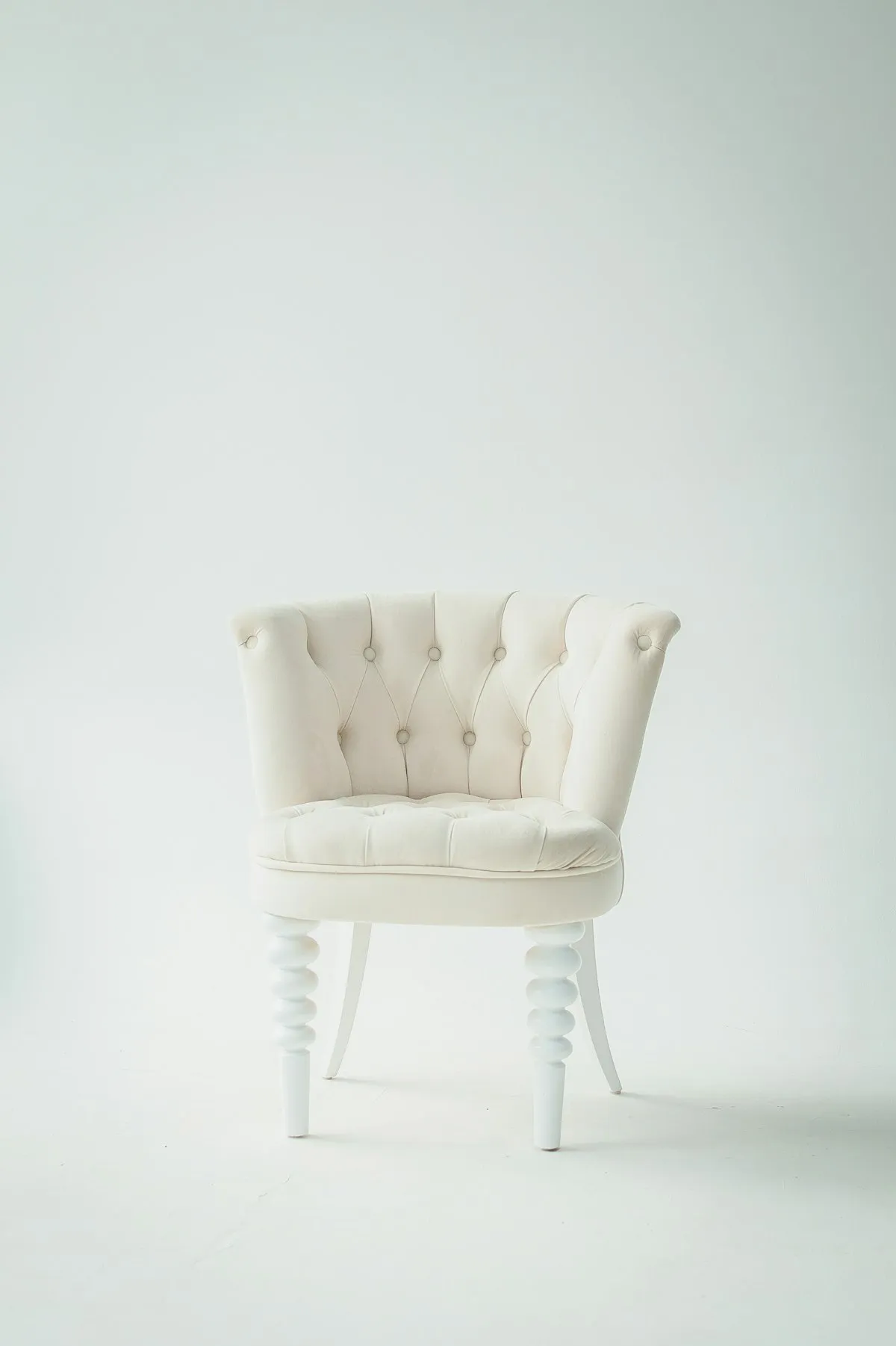 Slim mid-century wooden frame accent chair with exposed legs in a compact apartment living room