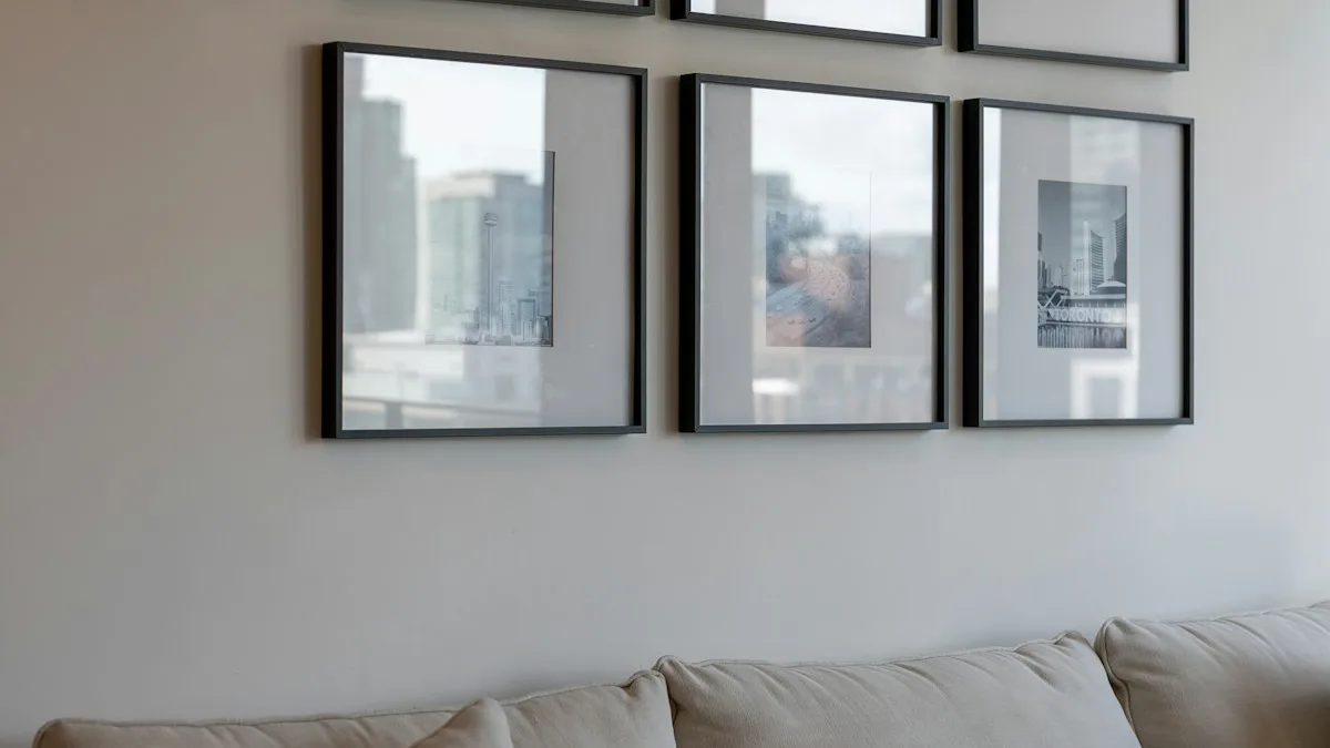 Modern 3 piece triptych canvas art hung with balanced 2 to 3 inch spacing over living room couch