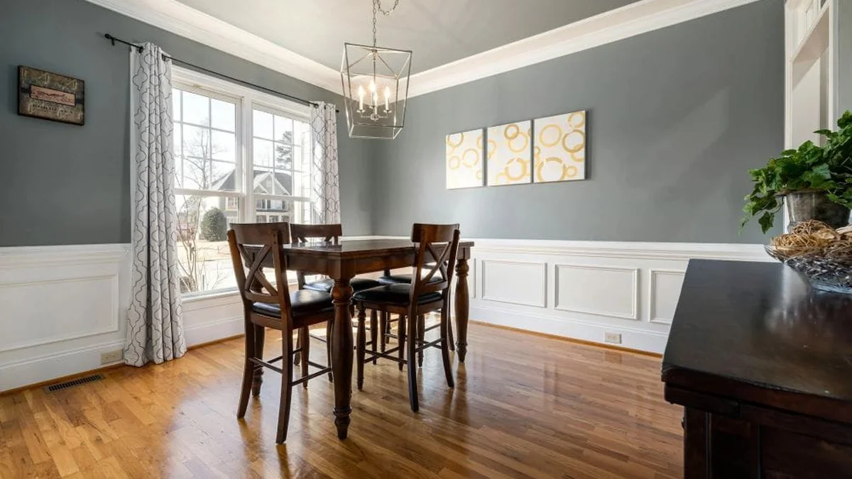 Classic dining room featuring picture frame wainscoting topped with chair rail moulding at one-third ceiling height