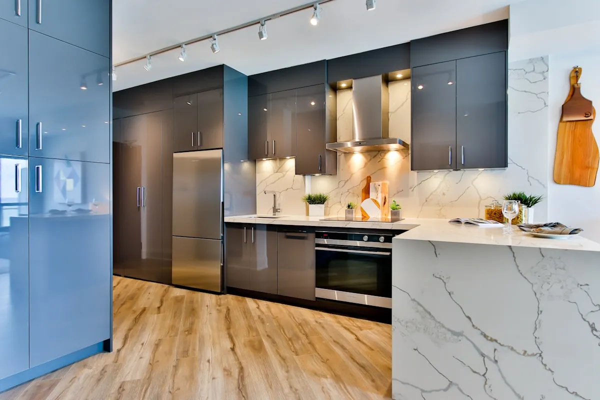 Close-up detail of modern cabinet hardware installed on clean kitchen cabinetry with warm task lighting