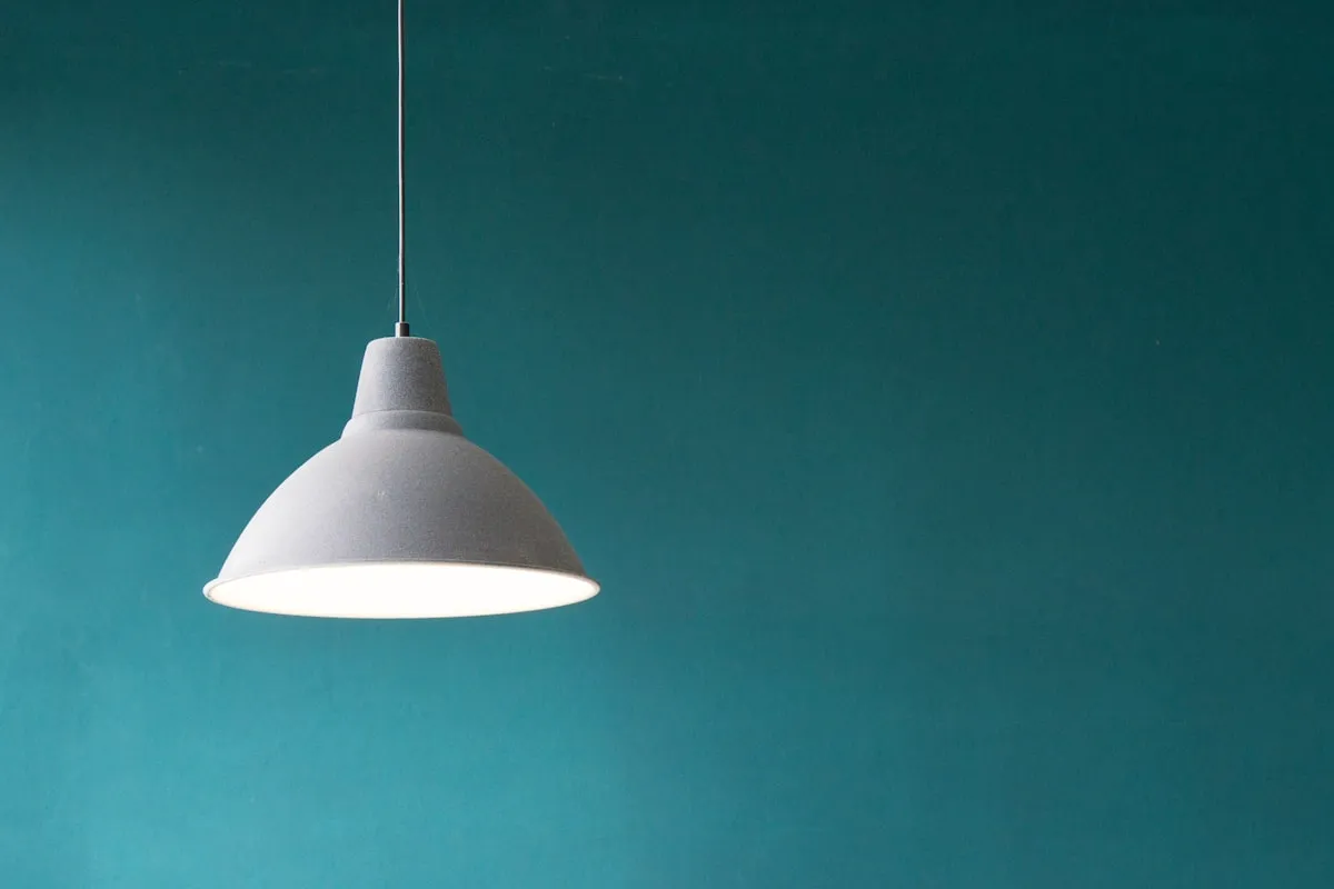 plug-in pendant lights for apartments - Modern apartment dining space illuminated by a warm hanging pendant light fixture with soft overhead glow